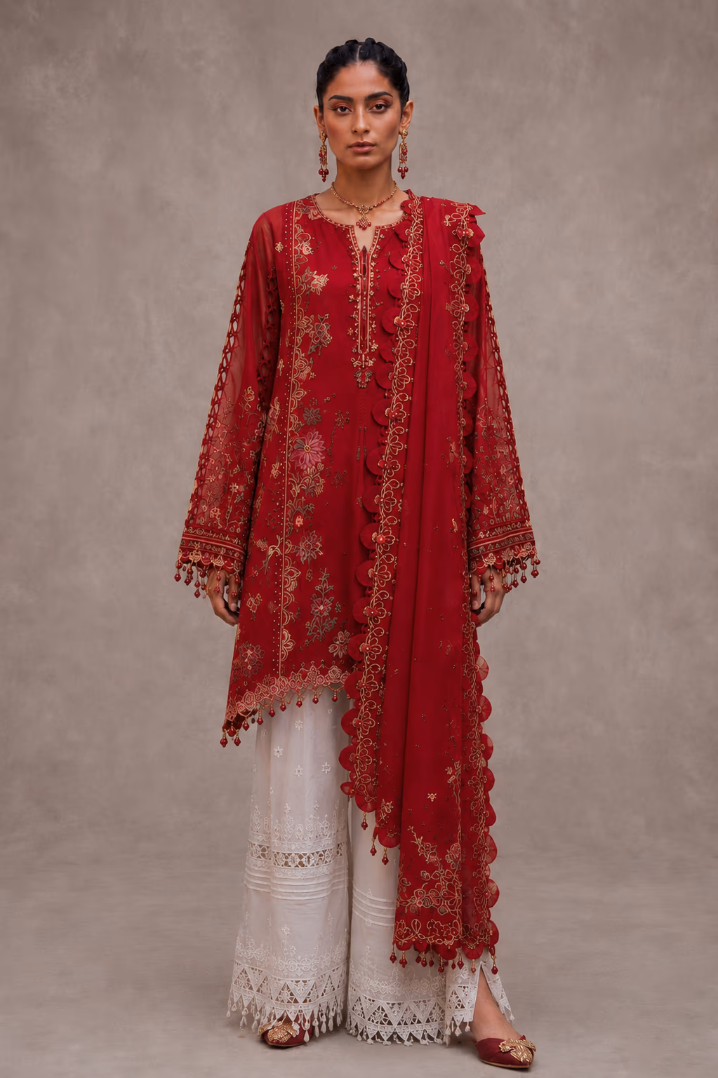 Original studio photograph of a model wearing a red embroidered outfit