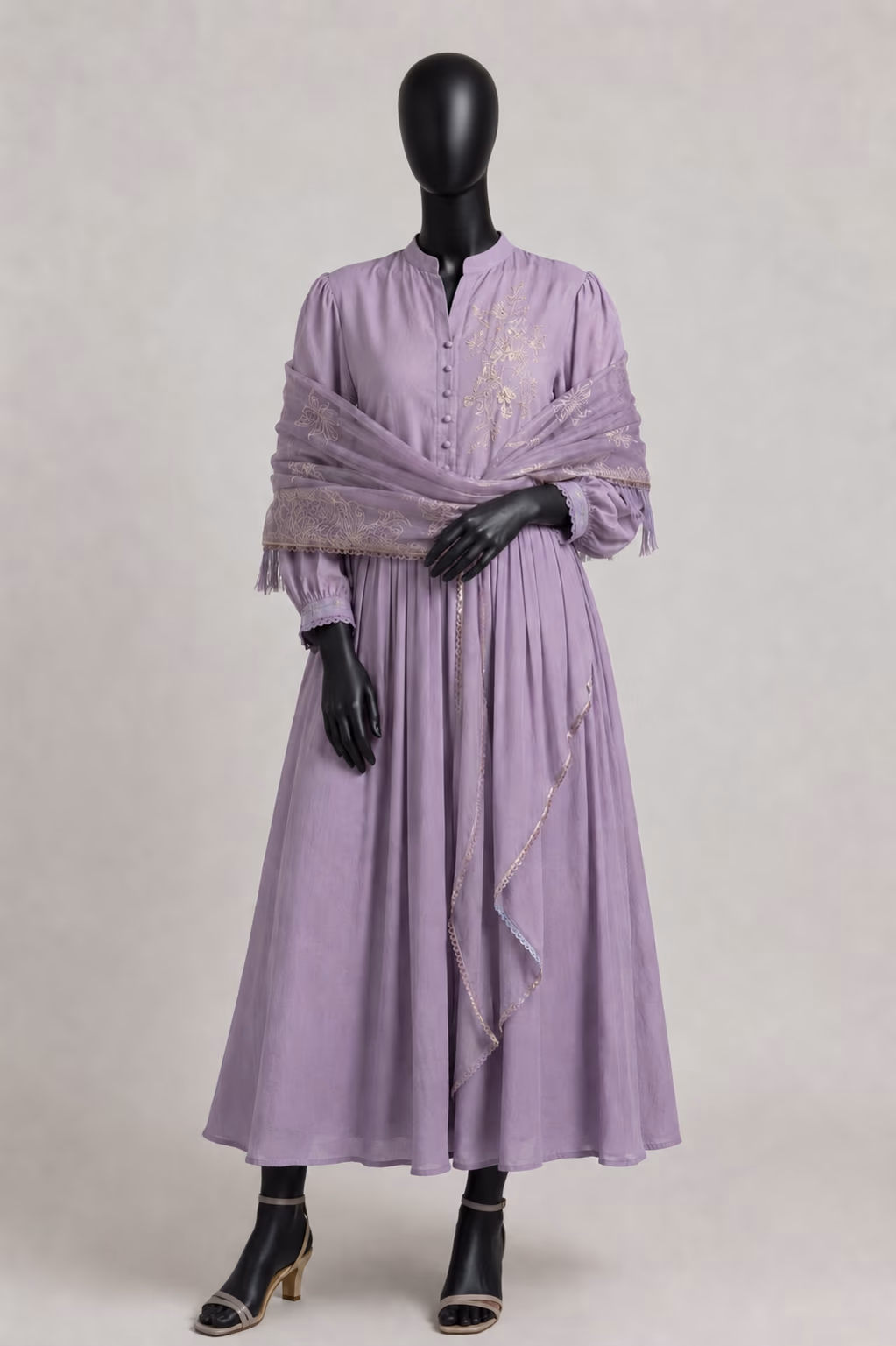 The same lilac dress shown on a matte black mannequin