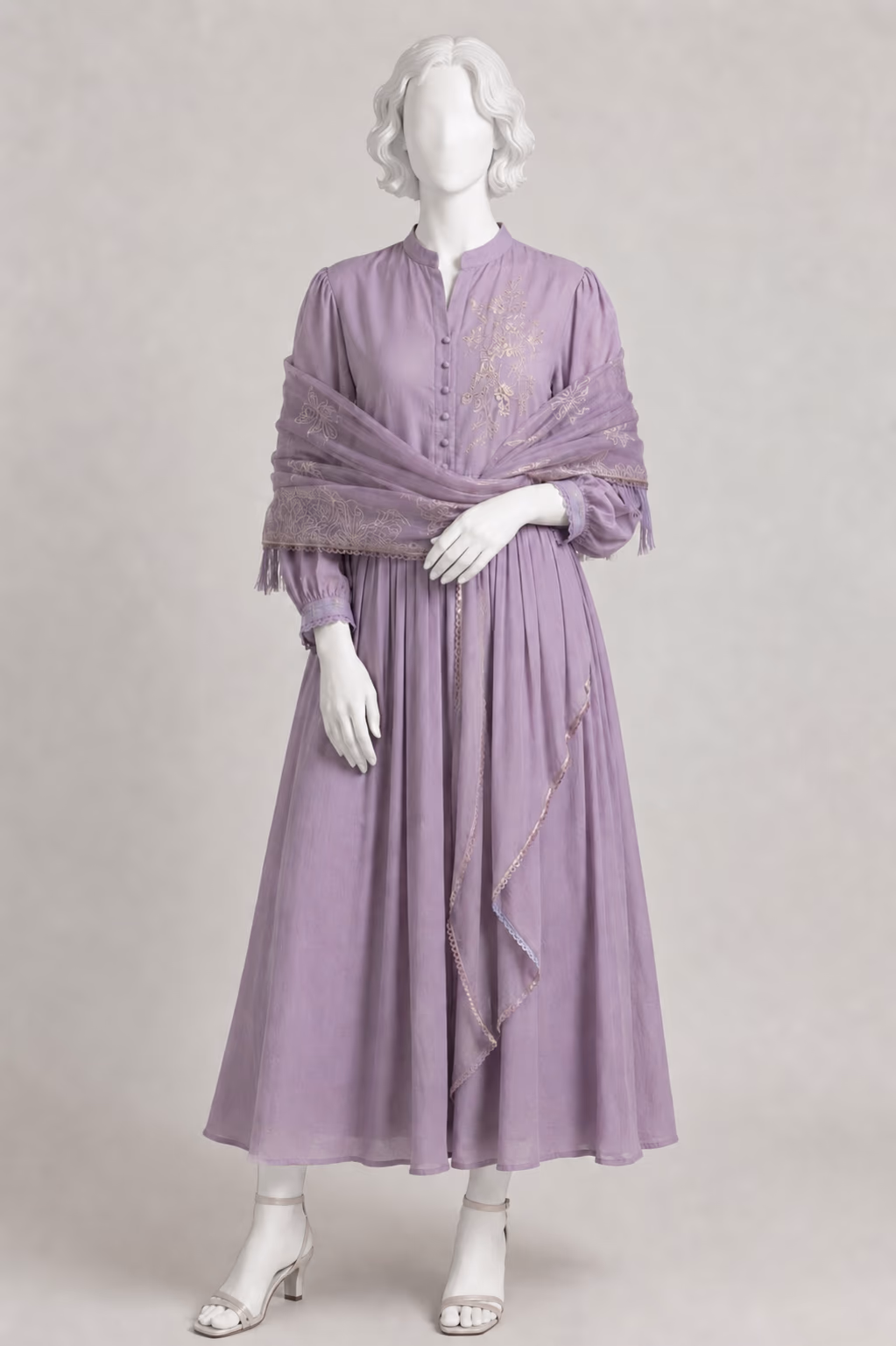 The same lilac dress shown on a sculpted white mannequin